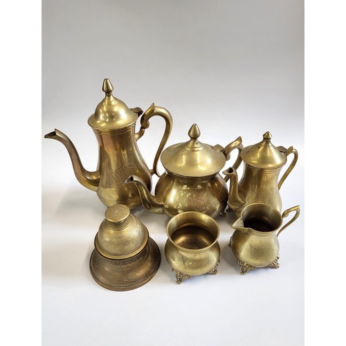 124 - A collection of brass pots, brass nutcracker, and a brass-wood carving set.