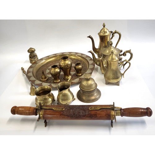 124 - A collection of brass pots, brass nutcracker, and a brass-wood carving set.