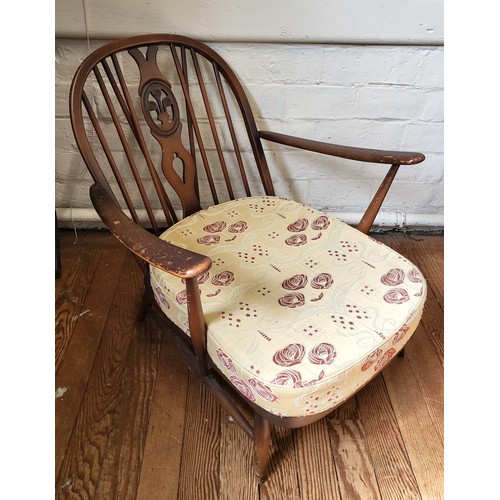 34 - An Ercol Windsor armchair with cushion. 80cm x 70cm x 90cm