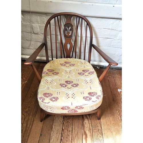 34 - An Ercol Windsor armchair with cushion. 80cm x 70cm x 90cm