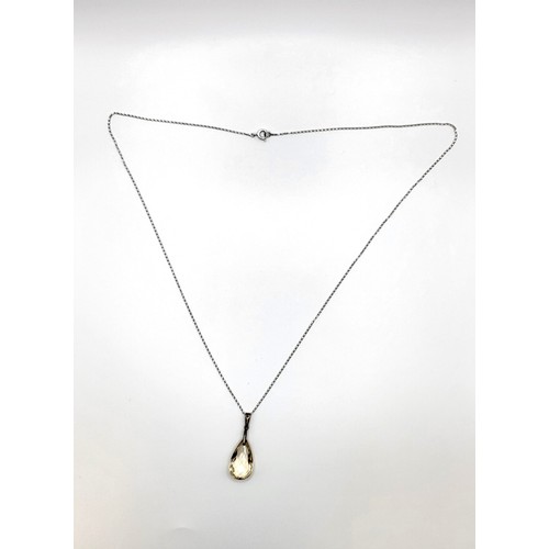 389 - A +25ct citrine pendeloque cut pendant (25mm x 15mm) on a chain 68cm 8.5gms all in.