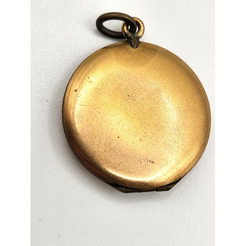 401 - A gold plate locket and a gold and machine turned silver pendant  with a central mill grained bosse ... 