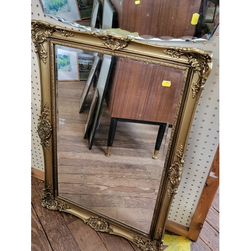 38 - Three mirrors: a 1950's scalloped edge mirror, a beveled mirror in a gilt frame, and an oval pine fr... 