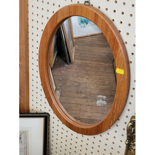 38 - Three mirrors: a 1950's scalloped edge mirror, a beveled mirror in a gilt frame, and an oval pine fr... 