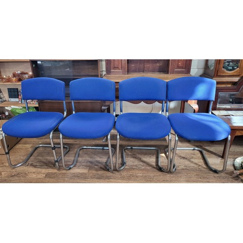 44 - Four 1970 chrome dining chairs with blue cloth covers. Some parcel tape residue on seats.