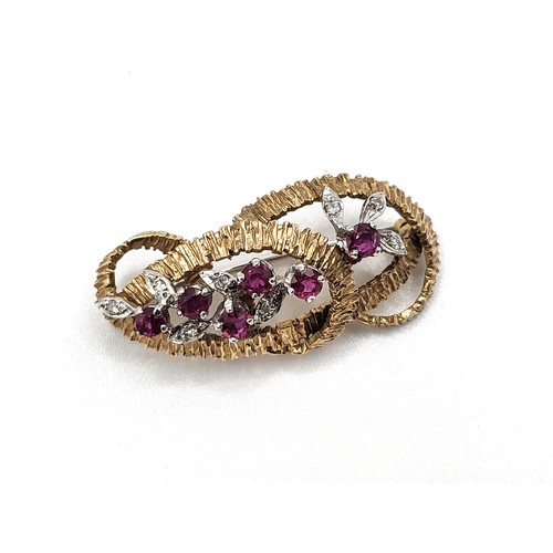 408 - A yellow and white gold twisted knot brooch set with round brilliant diamonds and six rubies. 6.8gms... 