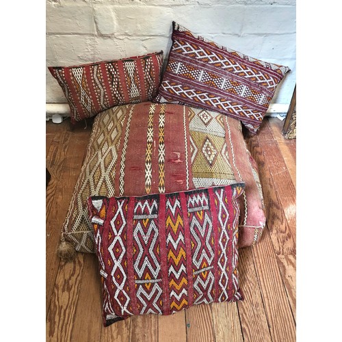 49 - Four Moroccan cushions including a large floor cushion and three smaller scatter cushions