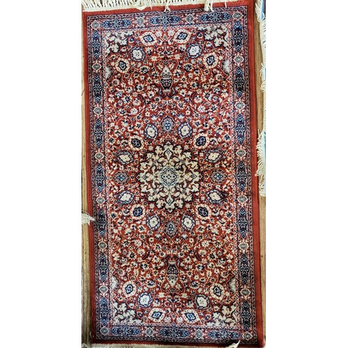 83 - A red and blue rug 140cm x 70cm