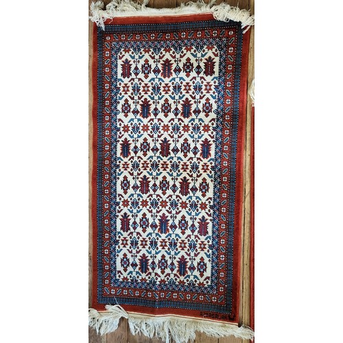 84 - A red, blue and cream rug, 120cm x 60cm