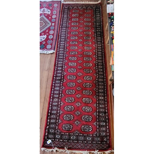 88 - A red hall runner 260cm x 80cm.