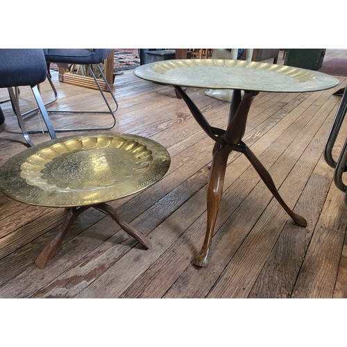 54 - Two folding tables with dog decoration on legs and a brass disc table top.