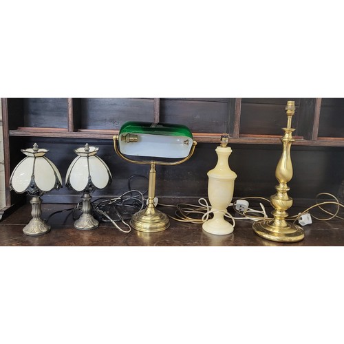 55 - A desk lamp, a marble lamp, two Tiffany style lamps and a brass lamp