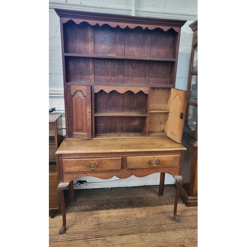 58 - A dresser with canopy rack and scalloped frieze over two long and two short shelves and flanking cup... 