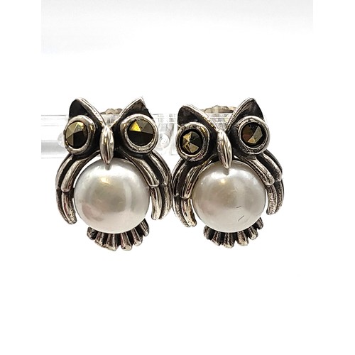 414 - A pair of pearl and marcasite in silver owl shaped earrings. Pearl 8.5mm.