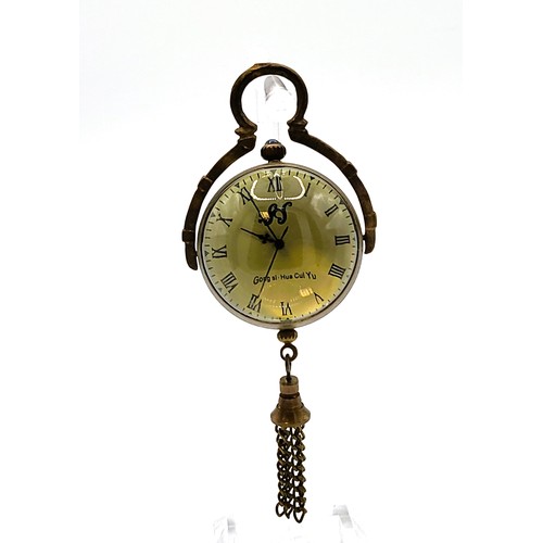 74 - A brass desk ball clock with Roman numerals with visible clocks workings 34.2gms 5cm drop