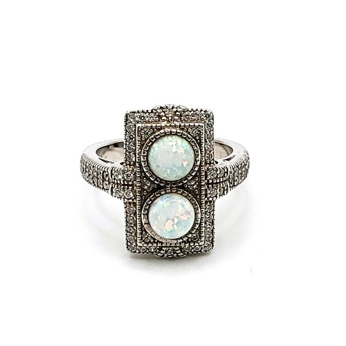 419 - A silver cubic zirconia and faux opal panelled ring in the Art Deco style. Size R 8.3gms