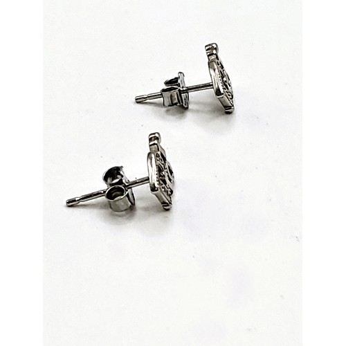 420 - A pair of silver and cubic zirconia designer style stud earrings. 1.2gms.