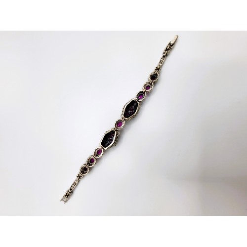 421 - A silver marcasite and natural ruby panther headed bracelet 19cm