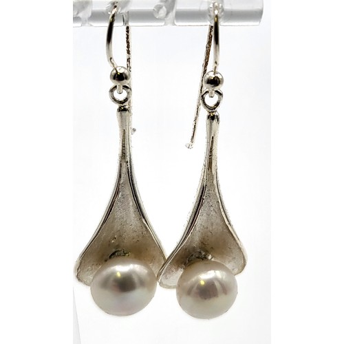 424 - A pair of silver and 10mm freshwater pearl earrings. 5cm drop x 1.5cm. 9.4gms