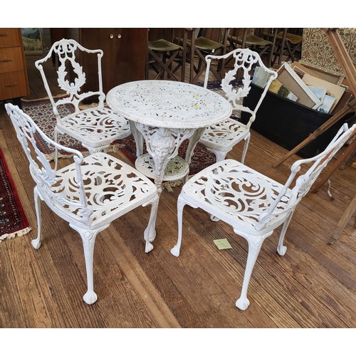 64 - A cast iron garden table and four chairs