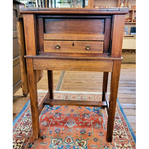 65 - A Mahogany sewing table complete with sewing accessories. 72cm x 50 x 38.