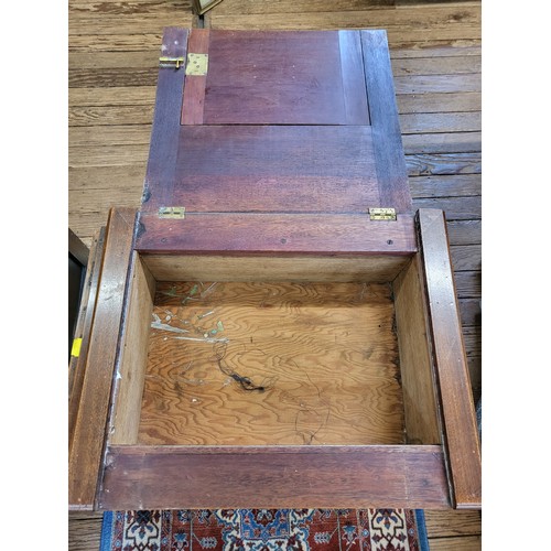 65 - A Mahogany sewing table complete with sewing accessories. 72cm x 50 x 38.