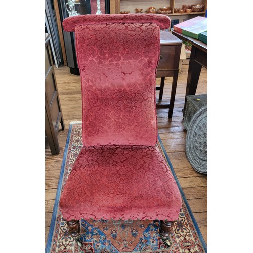 66 - An upholstered prayer chair, stud trim on the base of the chair, turned front legs, tapered back leg... 