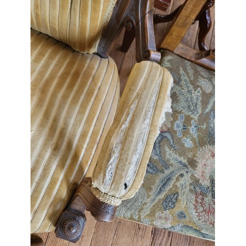 7 - A Victorian carved armchair button-back, padded arm rests, seat upholstery in needs of repair, on ca... 