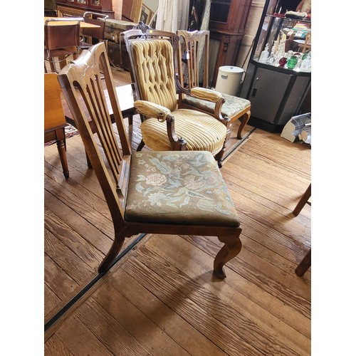 7 - A Victorian carved armchair button-back, padded arm rests, seat upholstery in needs of repair, on ca... 