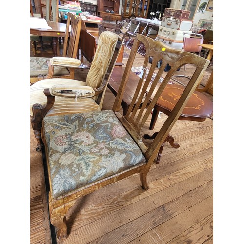 7 - A Victorian carved armchair button-back, padded arm rests, seat upholstery in needs of repair, on ca... 