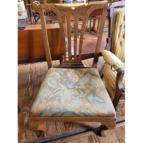 7 - A Victorian carved armchair button-back, padded arm rests, seat upholstery in needs of repair, on ca... 