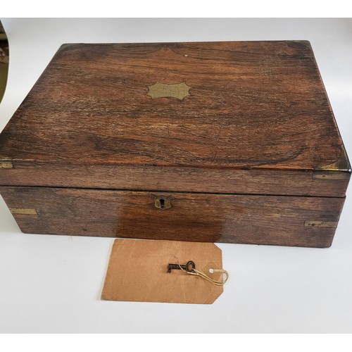 46 - A mahogany writing slope with key. Has purple interior, ink bottle and compartment for letters and p... 