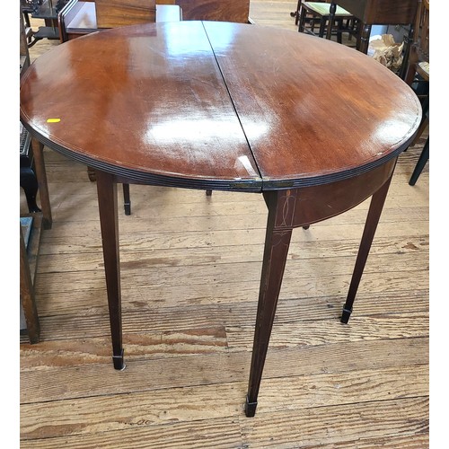 3 - An Edwardian mahogany circular table, can be folded to half moon. 73cm x 100cm