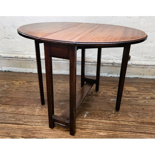 4 - A mahogany oval drop leaf table. 52cm x 73cm x 60cm