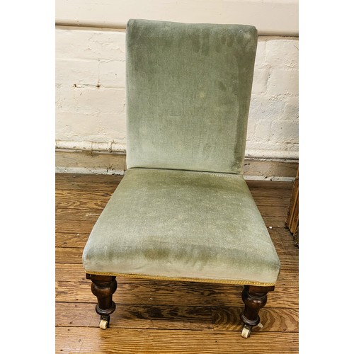 13 - A nursing chair upholstered in green with overstuffed back and seat, gold trim, and turned legs on c... 