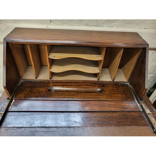 18 - A mahogany table when opened a writing bureau rises from within with cubby holes for letters, etc. o... 