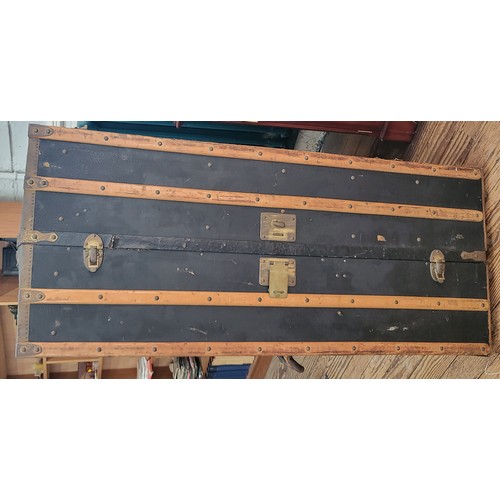 41 - A vintage/ antique steamer trunk with a cream coloured interior (shows signs of use). Has four drawe... 