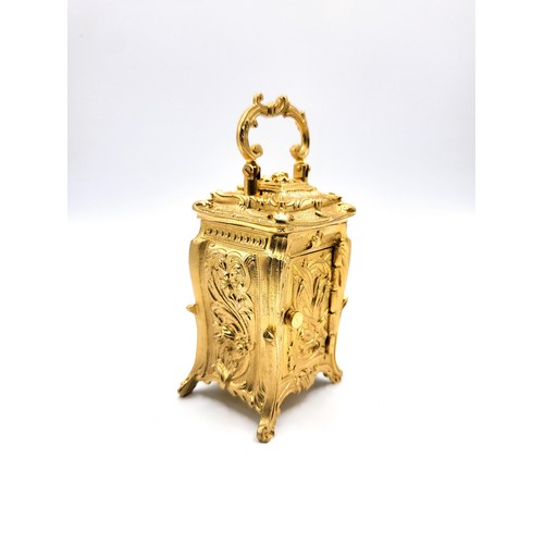 60 - An antique style Rococo cased miniature carriage clock with key. 10cm (including handle)