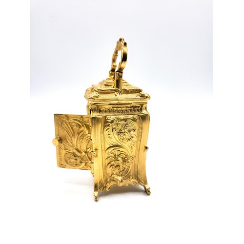 60 - An antique style Rococo cased miniature carriage clock with key. 10cm (including handle)