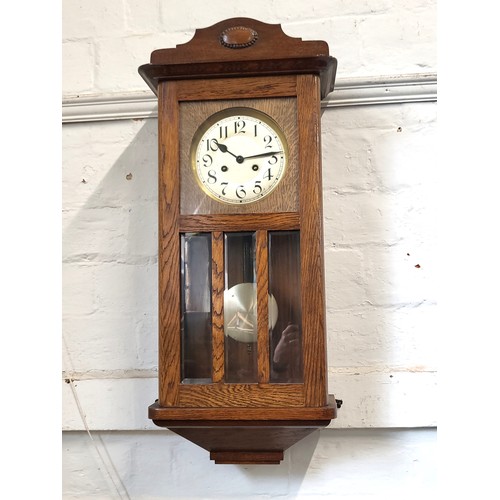 63 - An oak hall clock 82cm.