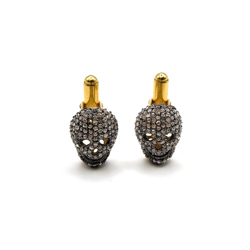 364 - A pair of gold-plated silver skull cufflinks set with rose cut diamonds. Diamonds approx. 1.80ct.