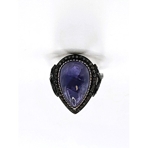 366 - A pear-shaped cabochon tanzanite and diamond-framed ring in gold-plated silver (unmarked). tanzanite... 