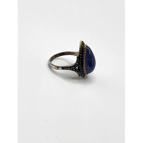 366 - A pear-shaped cabochon tanzanite and diamond-framed ring in gold-plated silver (unmarked). tanzanite... 