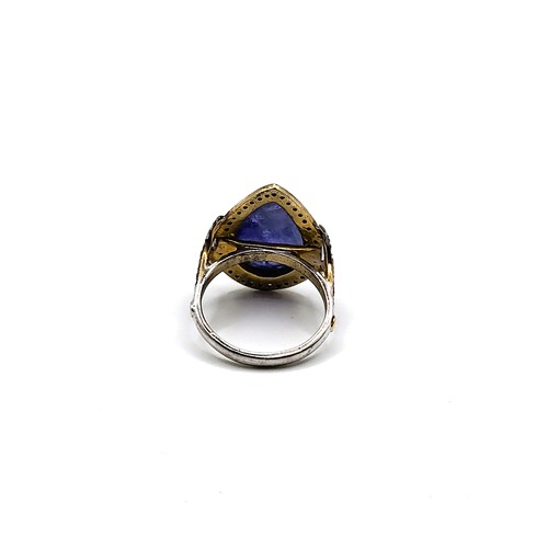 366 - A pear-shaped cabochon tanzanite and diamond-framed ring in gold-plated silver (unmarked). tanzanite... 