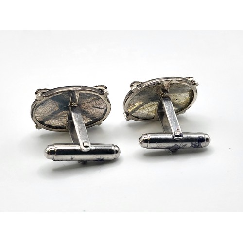 379 - A pair of large oval cufflinks set with labradorite, sapphires, and diamonds, in white metal, boxed.... 