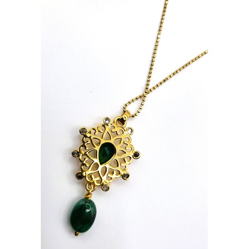 383 - A fancy pendant in yellow metal set with diamonds, a pear-shaped emerald, a suspended polished emera... 