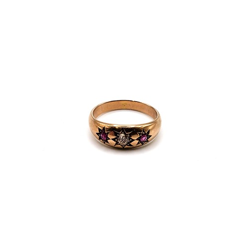 384 - A 9ct rose gold gypsy ring set with an old mine cut yellow diamond flanked by round cut rubies with ... 