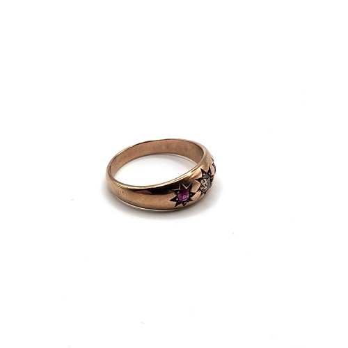 384 - A 9ct rose gold gypsy ring set with an old mine cut yellow diamond flanked by round cut rubies with ... 