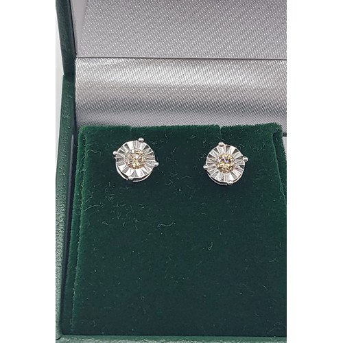 390 - A pair of 9ct white gold illusion-set round brilliant cut cinnamon colour diamond solitaire studs, b... 