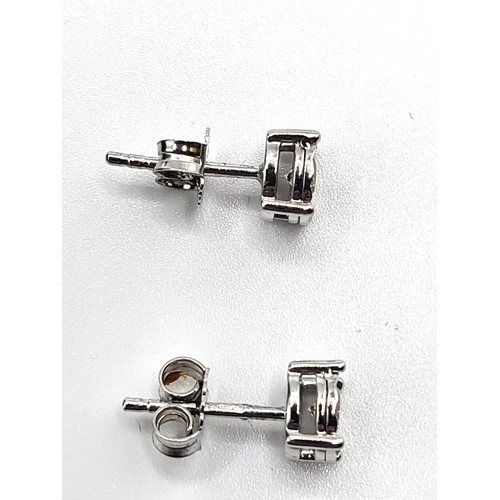 390 - A pair of 9ct white gold illusion-set round brilliant cut cinnamon colour diamond solitaire studs, b... 